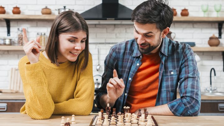 portrait-young-couple-playing-chess-kitchen